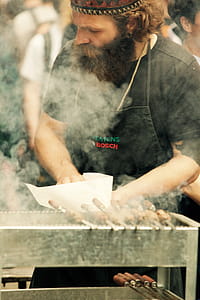 Man Standing in Front of Grill thumbnail