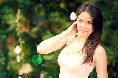 woman wearing tank top with flower on ear thumbnail