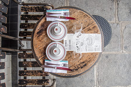 white-and-red ceramic teacups and saucers on round brown table thumbnail