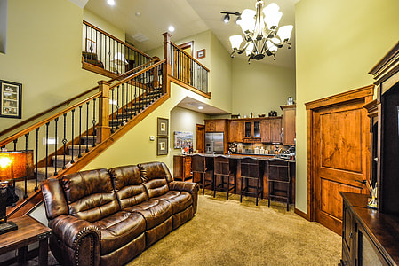 brown leather reclining sofa beside staircase in a room thumbnail