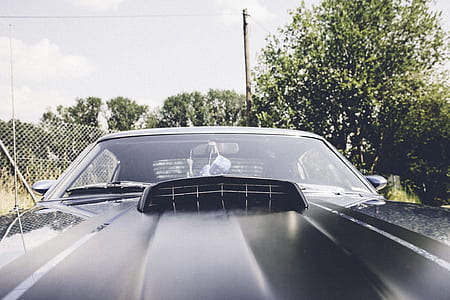 parked black muscle car thumbnail