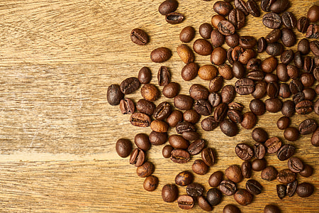 brown coffee beans on brown wooden surface thumbnail
