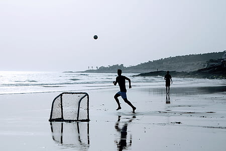 two men playing on shore thumbnail