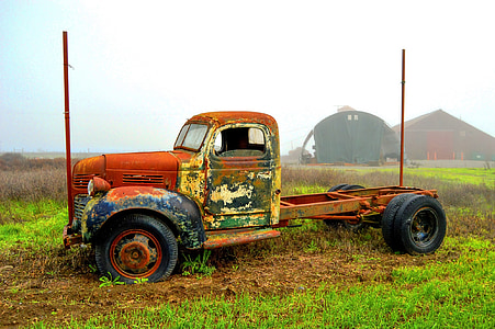brown truck on grass field during daytime thumbnail