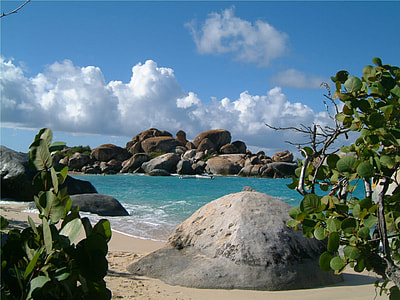 rock formation on ocean under blue and cloudy sky at daytime thumbnail