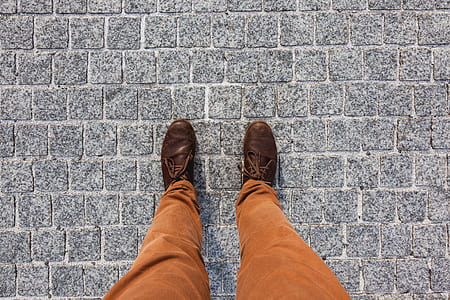 person standing on gray concrete ground during daytime thumbnail