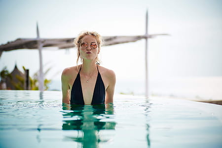 woman wearing black swimsuit in pool during daytime thumbnail