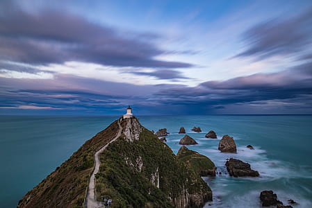 white lighthouse on top of mountain thumbnail