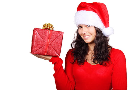 woman wearing Santa hat while holding red gift thumbnail
