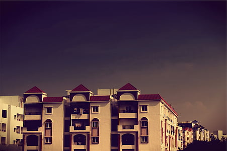white and red concrete building under blue sky at daytime thumbnail