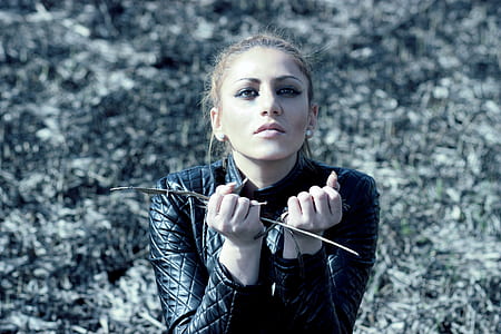 close-up photography of woman wearing quilted black leather jacket thumbnail