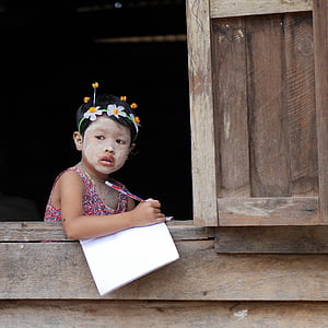 girl holding pencil and white lined paper thumbnail