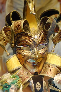 close-up photography of gold floral jester clown mask thumbnail