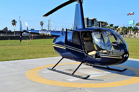 black helicopter on helipad near green grass field thumbnail