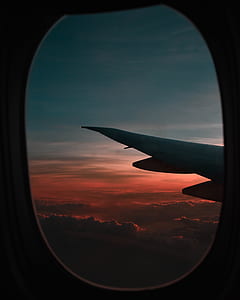 photo of clouds taken inside plane near its wing thumbnail