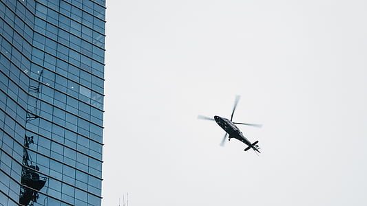 flying helicopter near building thumbnail