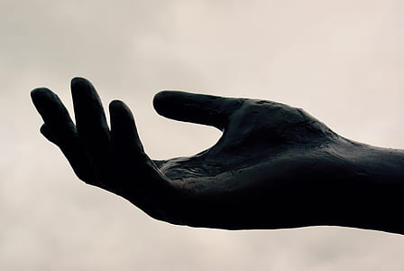 black hand statue in close-up photography thumbnail