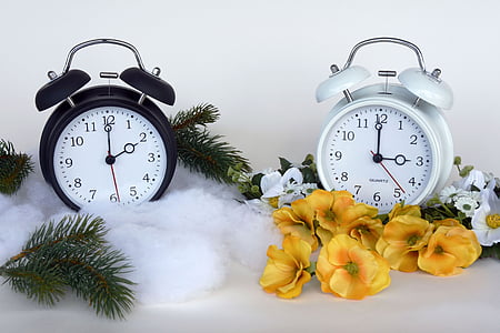 two white and black analog alarm clocks thumbnail