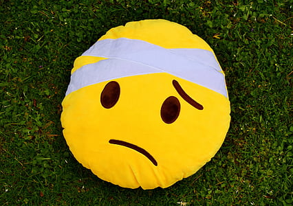 yellow sad emoji pillow on grass fifeld thumbnail
