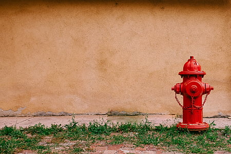 red water hydrant near concrete wall at daytime thumbnail