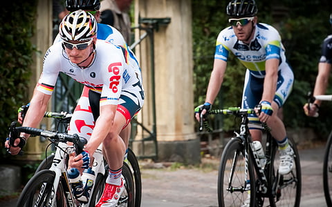 three men riding road bicycles by day thumbnail