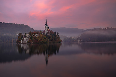 castle on island surrounded with body of water thumbnail
