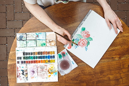 person painting red rose using water color thumbnail