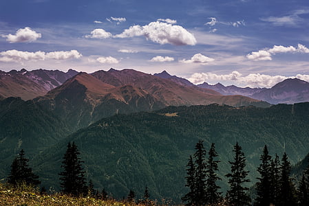 top view of mountains under cloudy clouds during daytime thumbnail