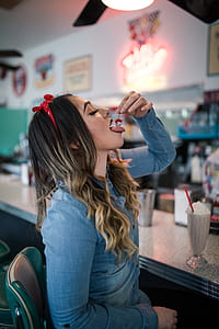 woman putting cherry on her mouth thumbnail