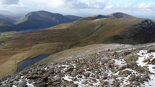 photo of person standing on hill under blue sky at daytime thumbnail