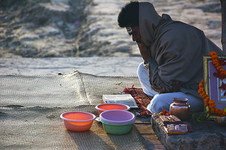 man sitting on brown mat reading textbook thumbnail