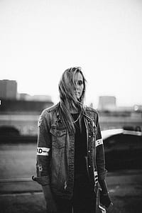 grayscale photography of woman wearing denim jacket thumbnail