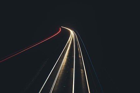 time lapse photography of running lights on road during night thumbnail