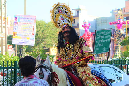 man wearing traditional costume while riding white horse thumbnail