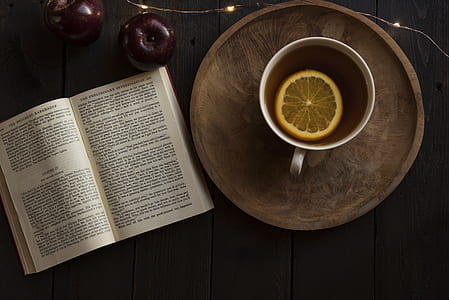 white ceramic mug on top of round brown wooden tray beside book thumbnail