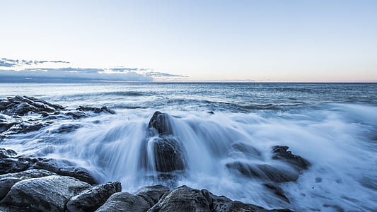 time lapse photo of flowing water on rocks during daytime thumbnail