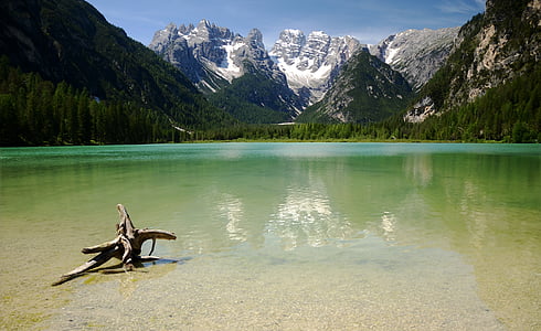body of water overlooking mountains during daytime thumbnail