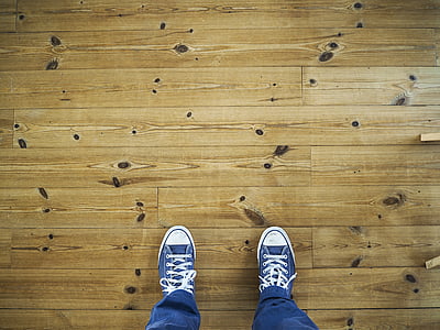 high angle photo of person wearing pair of blue sneakers thumbnail