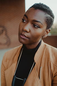 woman wearing brown blazer and black top thumbnail