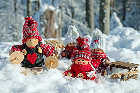 wooden dolls on snow-covered ground thumbnail