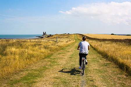 woman riding bicycle in grass field thumbnail