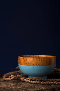 brown and blue bowl on brown surface thumbnail