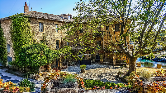 photo of brown building and green leafed trees thumbnail