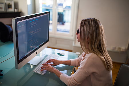 woman facing silver iMac thumbnail