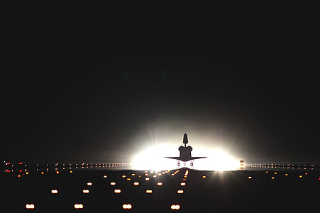 plane on runway road during night thumbnail