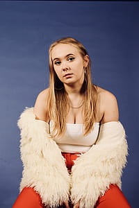 Woman Wearing White Top and Beige Coat thumbnail