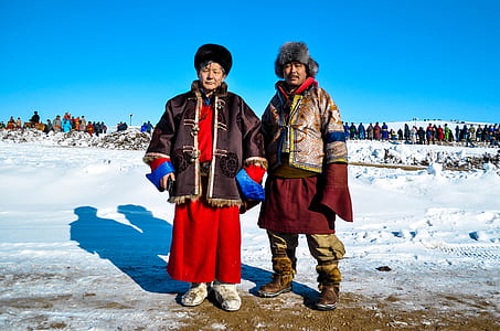 man and woman standing near snows thumbnail