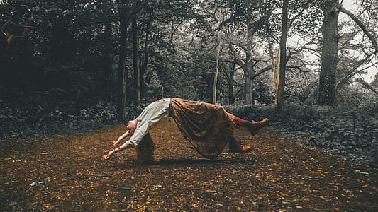 floating female surrounded by trees over dried leaves thumbnail