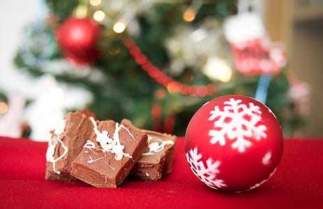 red and white baubles beside chocolate on red surface thumbnail