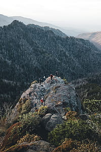 aerial photography of group of people on mountain top during day thumbnail